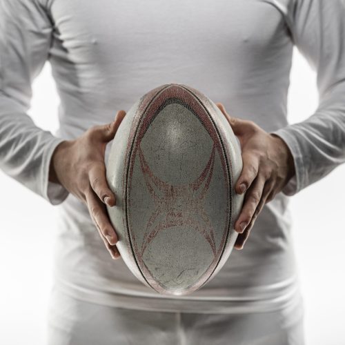 front-view-male-rugby-player-holding-ball-with-both-hands